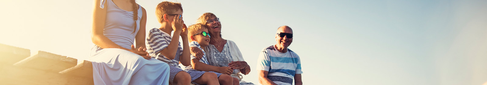 family sitting on dock