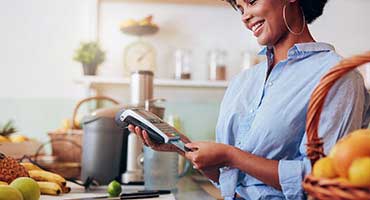 Woman making a purchase with a debit card.