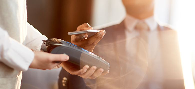 Accepting a contactless payment using a handheld Merchant Services terminal.