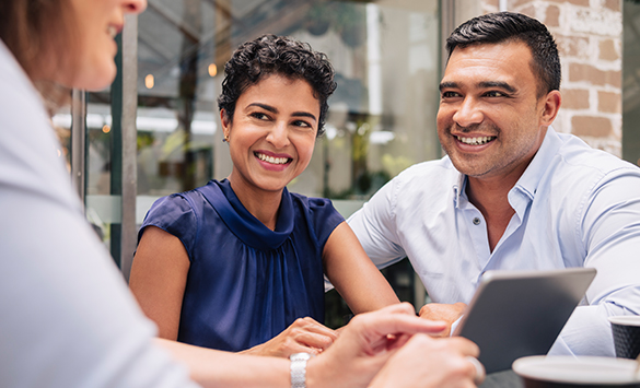 Couple discussing personal wealth solutions with an advisor.