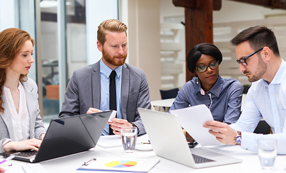 Team of four trust bankers and wealth advisors collaborating to provide services need to meet client wealth goals.