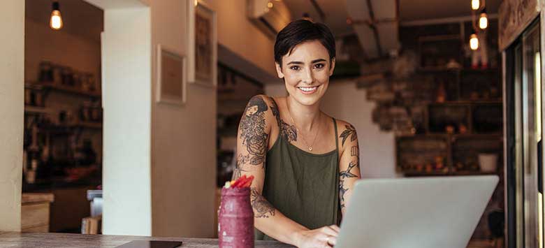 Young business owner managing her account online.